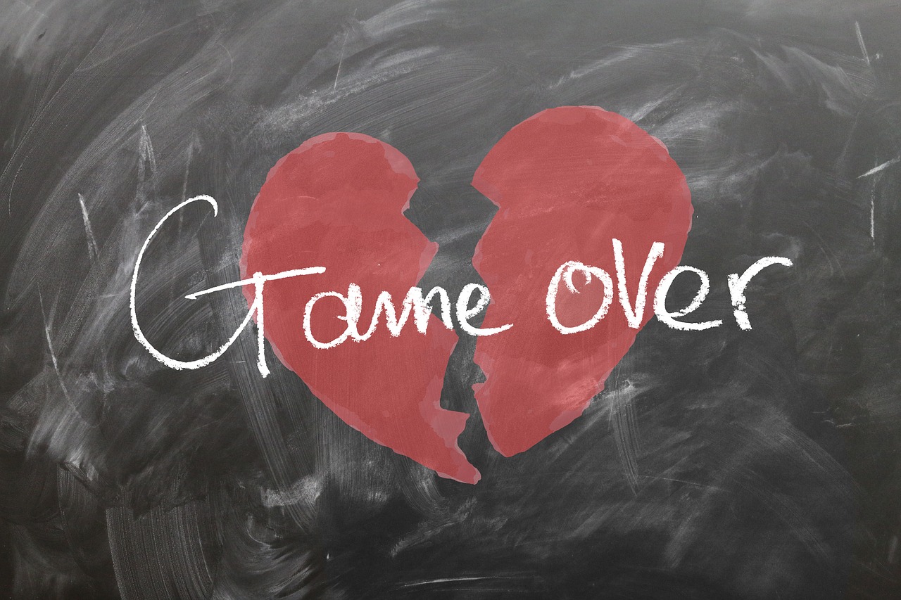 Picture of a heart split in two with the words "game over".