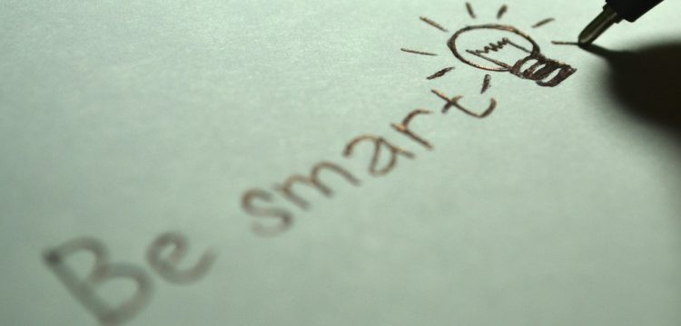 Someone writing the words, "Be smart".
