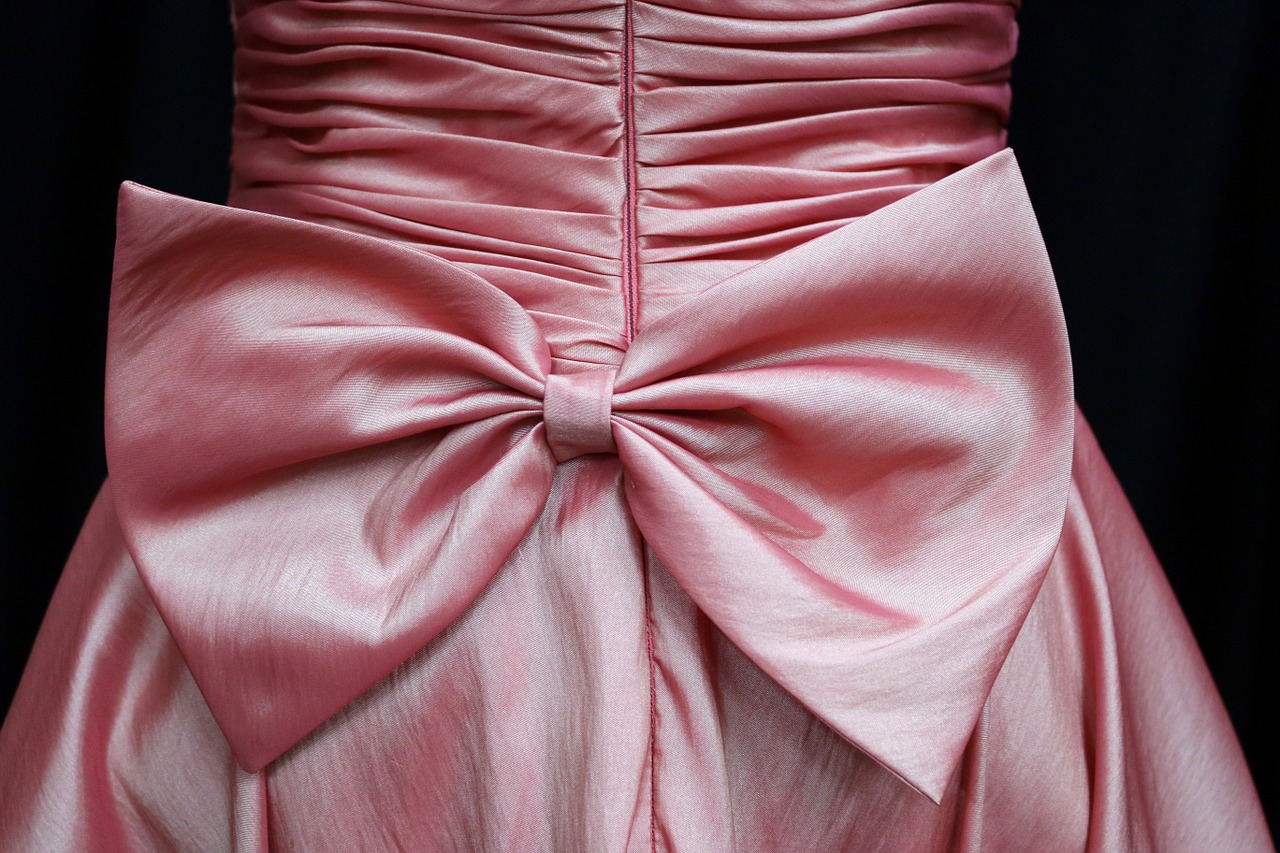 The back of a bridesmaid's dress which has a big bow on it.