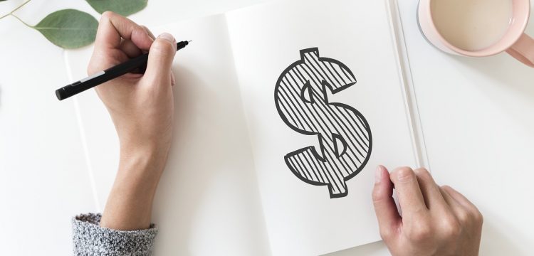 A hand drawn picture of a dollar sign on a notebook.