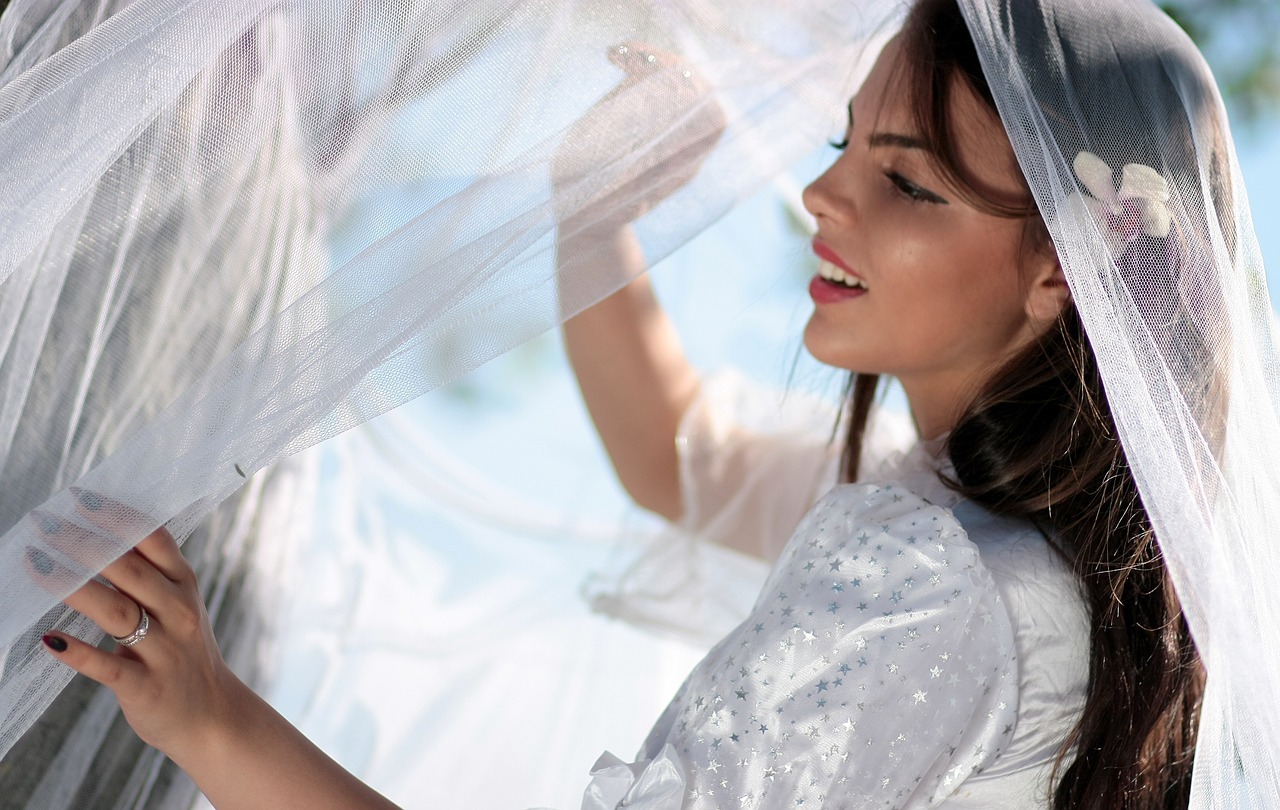 Bride holding a wedding veil.