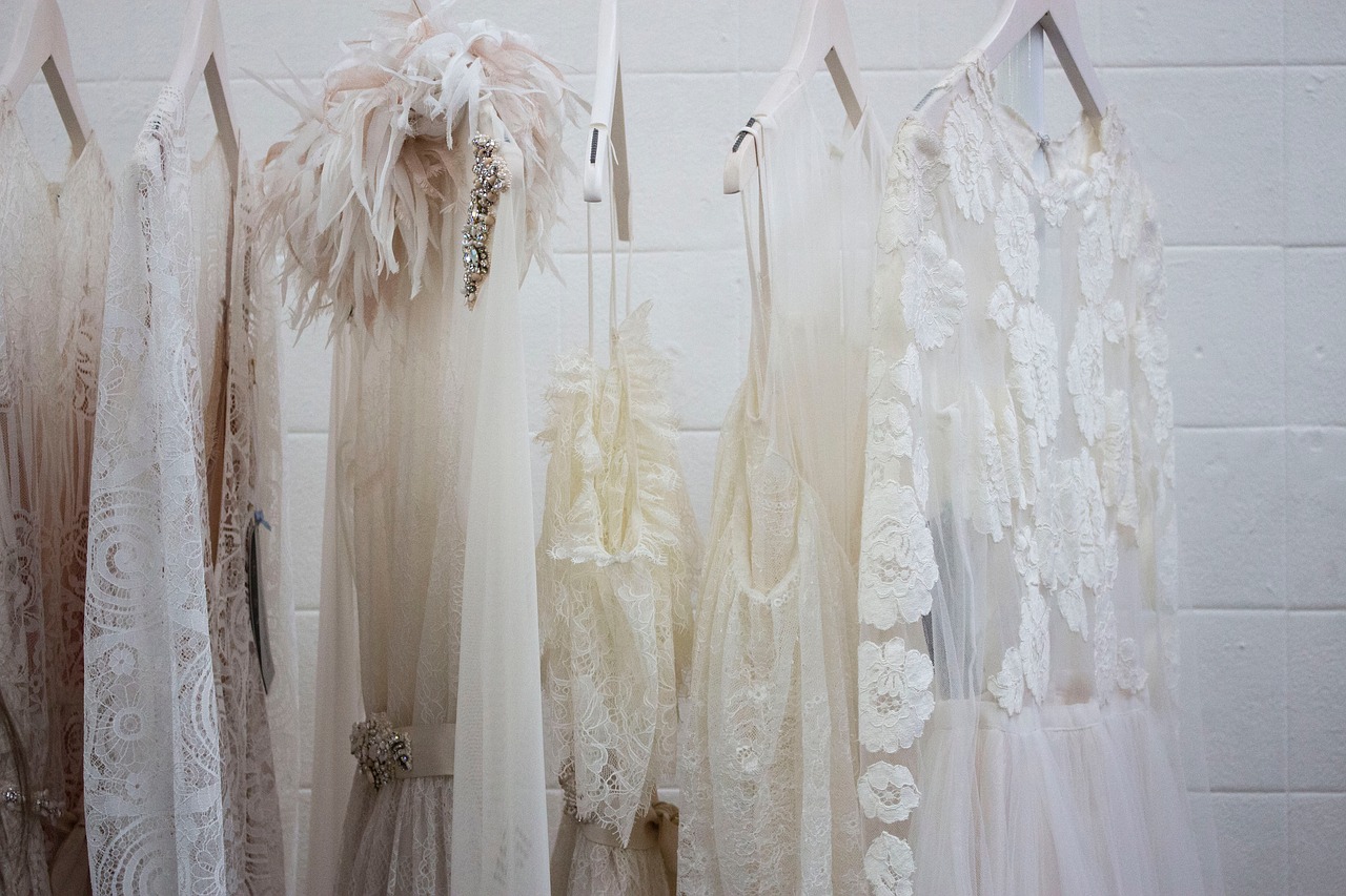 A row of wedding gowns hanging.