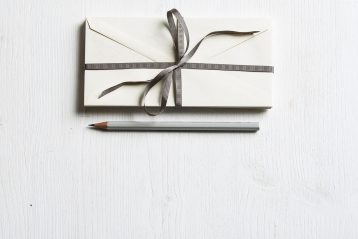 A wedding invitation and pen.