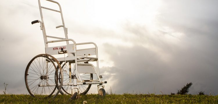 A wheelchair parked on the lawn.