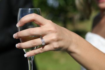 Bride holding a champagne glass.