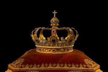 A crown sitting on a pillow.