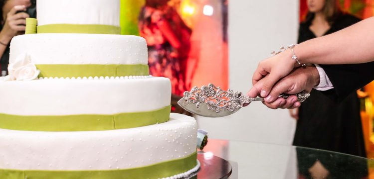 Couple cutting a wedding cake.