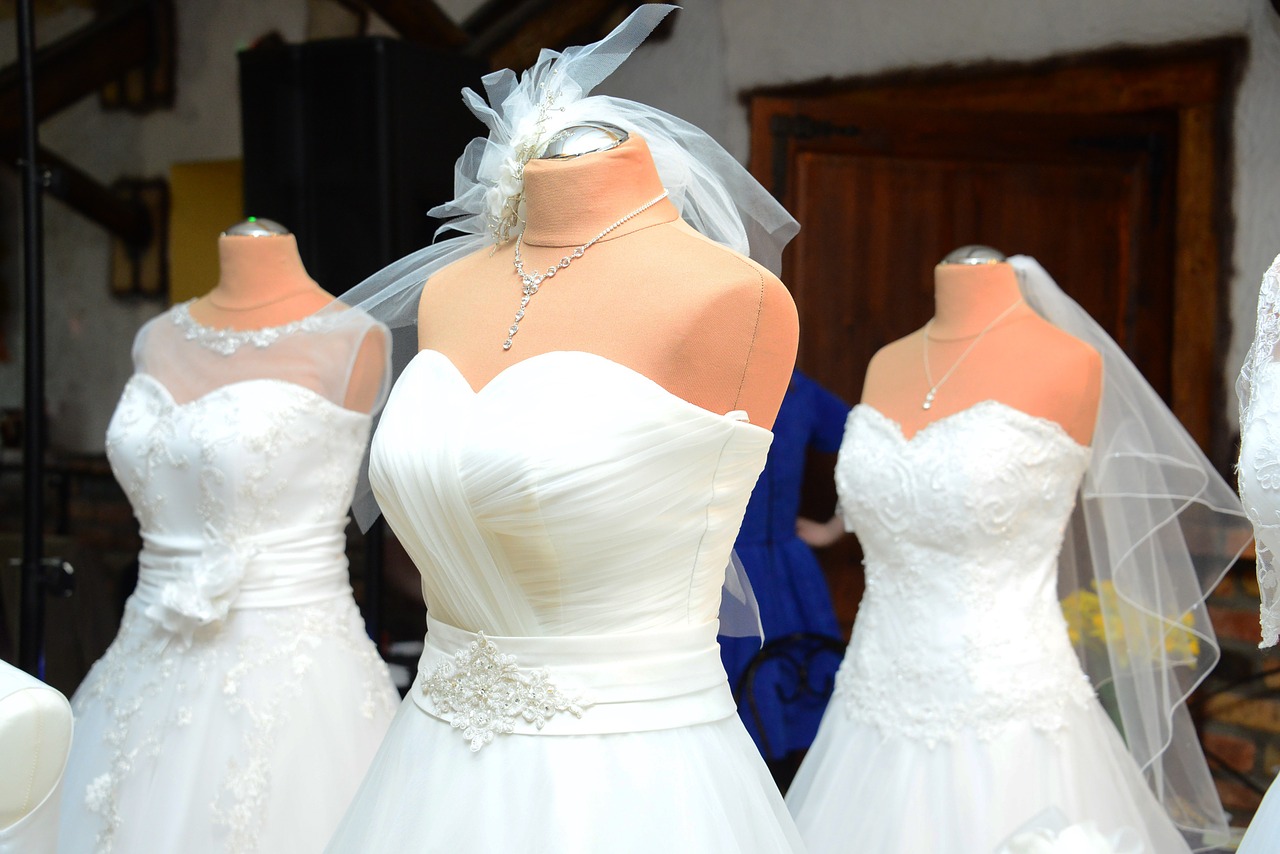Three wedding dresses on mannequins.