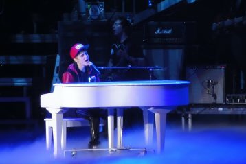 Justin Bieber, sitting at a piano.