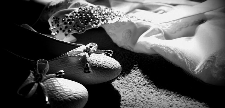 Black and white picture of wedding shoes, tiara, etc.