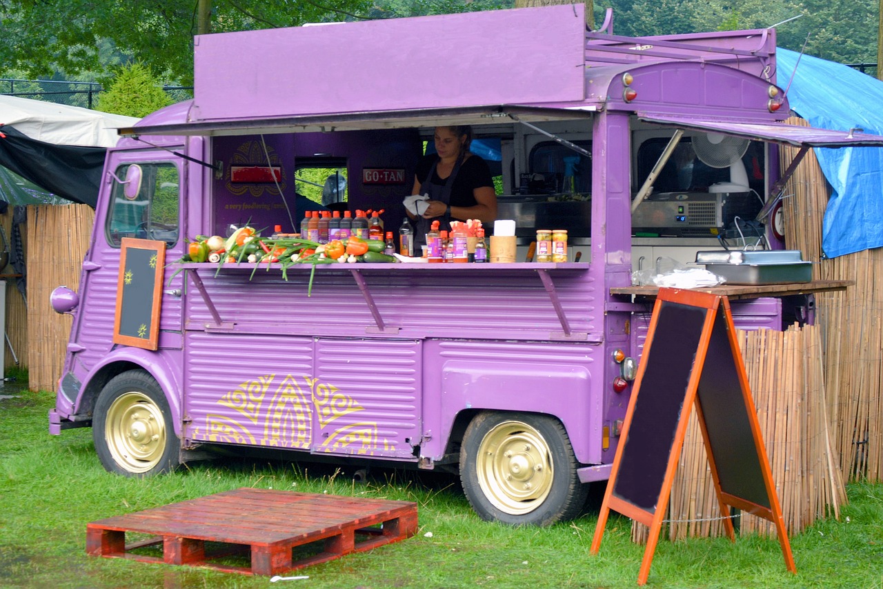A purple food truck, serving drinks and food.