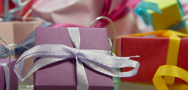 A bunch of neatly wrapped gifts with bows.