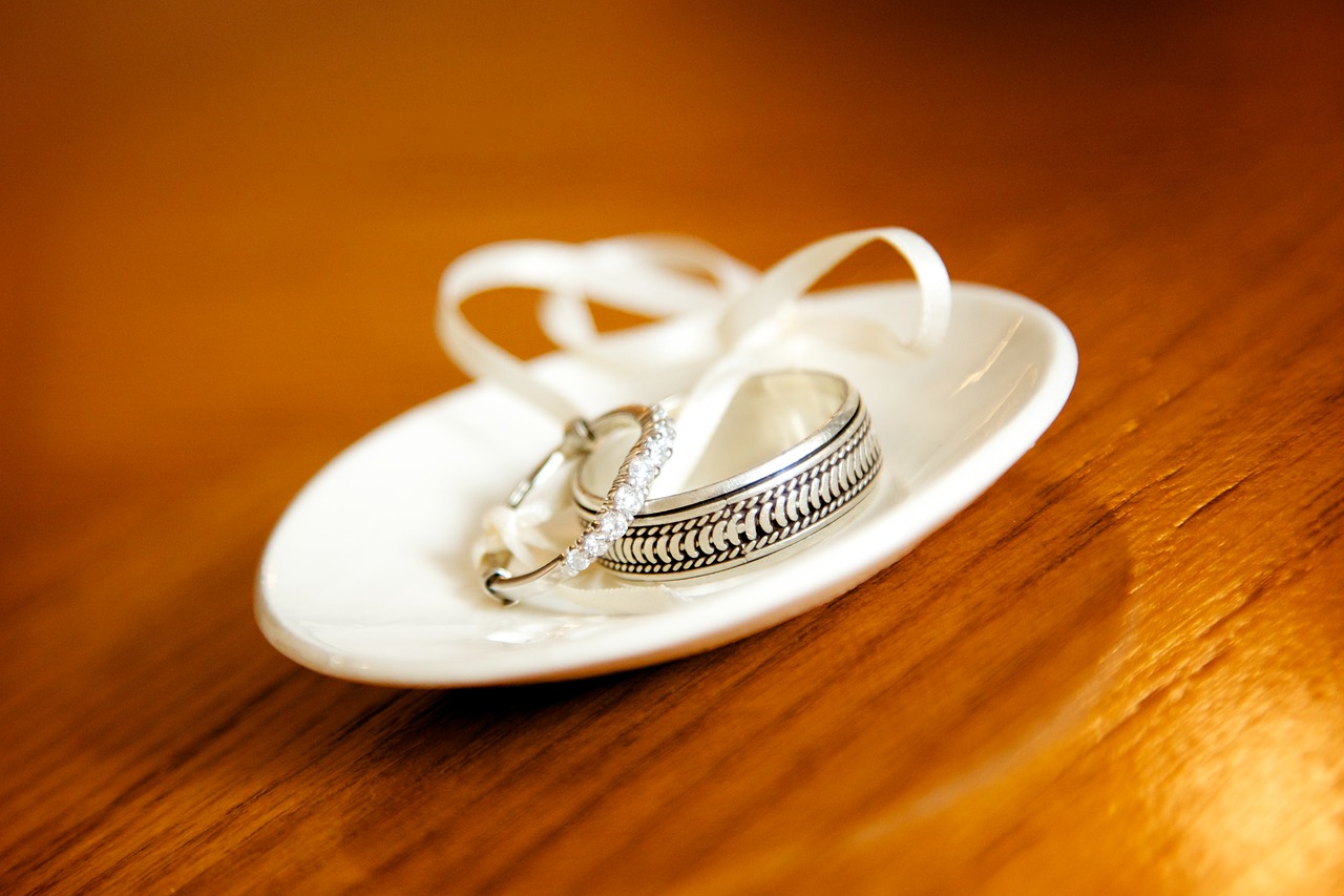 Woman's and man's wedding bands on a dish.