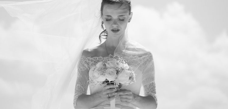 Black and white photo of a bride holding a bouquet.