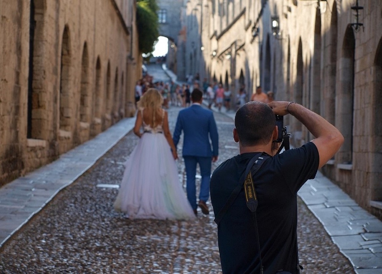 Photographer taking a picture of a bride and groom.