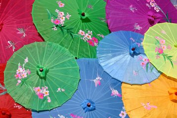 A bunch of overlapping colorful Japanese parasols.