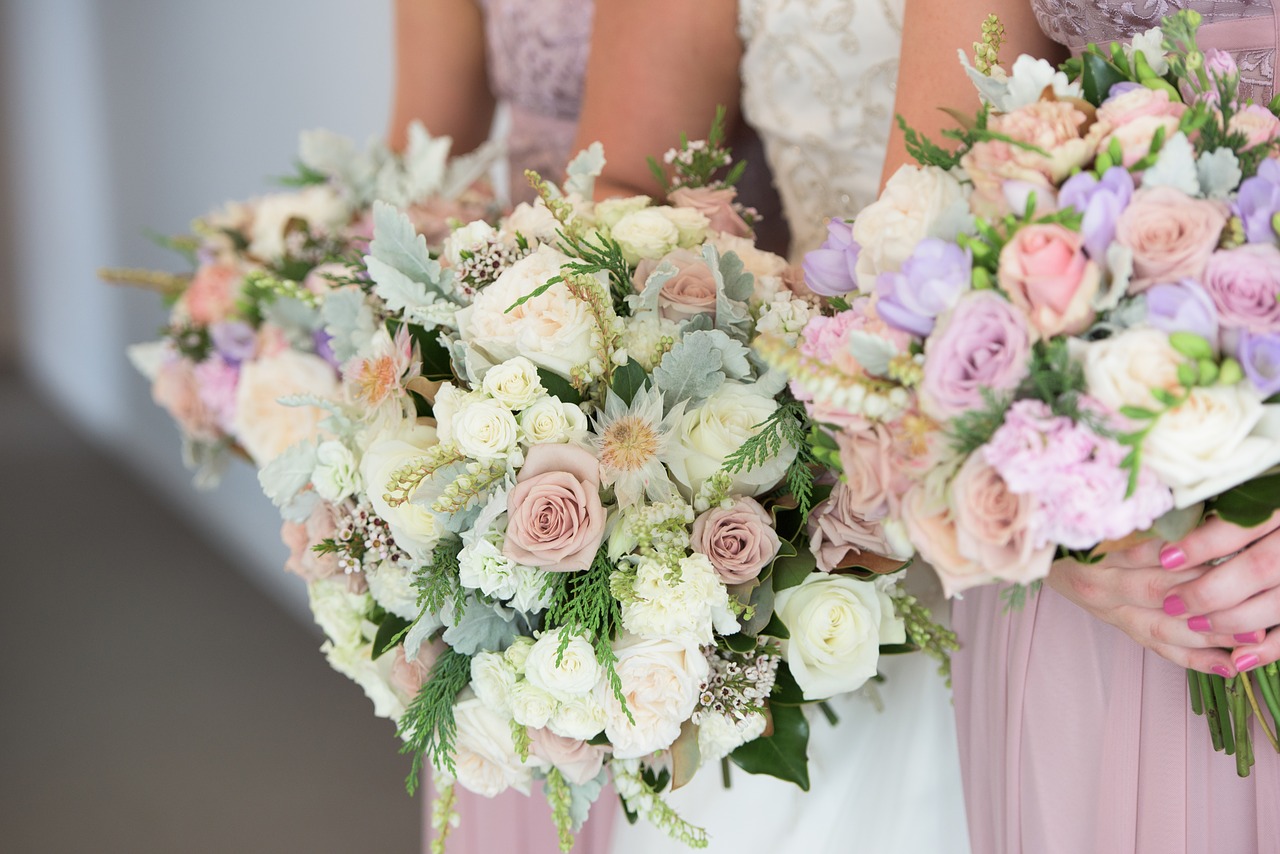 Bride and attendants holding wedding bouquets.