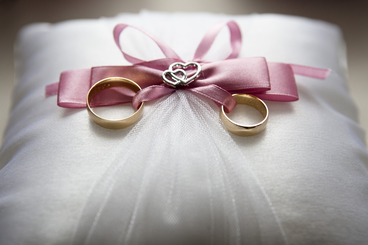 Wedding rings tied to a pillow.