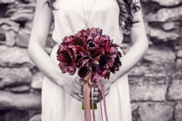 Bridesmaid holding bouquet.