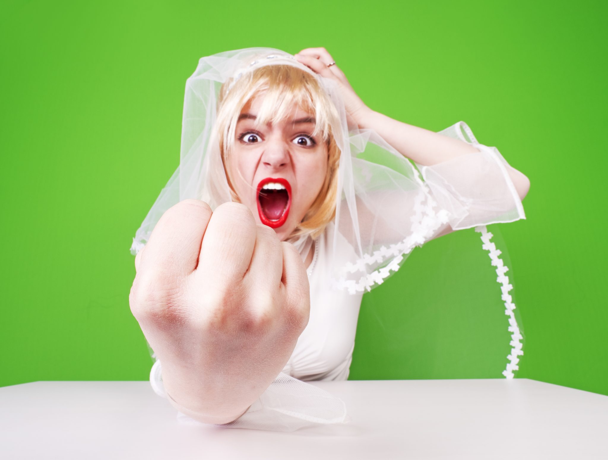 Angry bride clenching her fist.