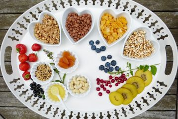 Platter full of vegan food alternatives, including some in heart-shaped bowls.
