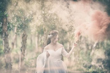 Bride walking through a field or forest.
