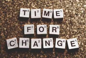 Scrabble letters that spell out "Time for Change".