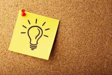 A sticky note with a light bulb on it to denote the word "idea".