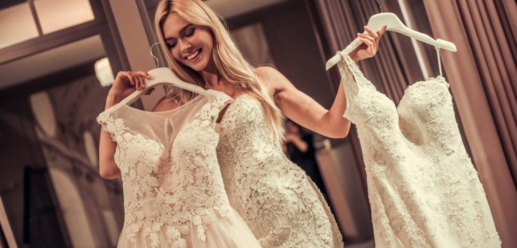 A bride trying on gowns.