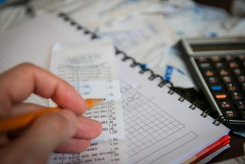 Receipts, a calculator, and graph notebook, indicating taxes.