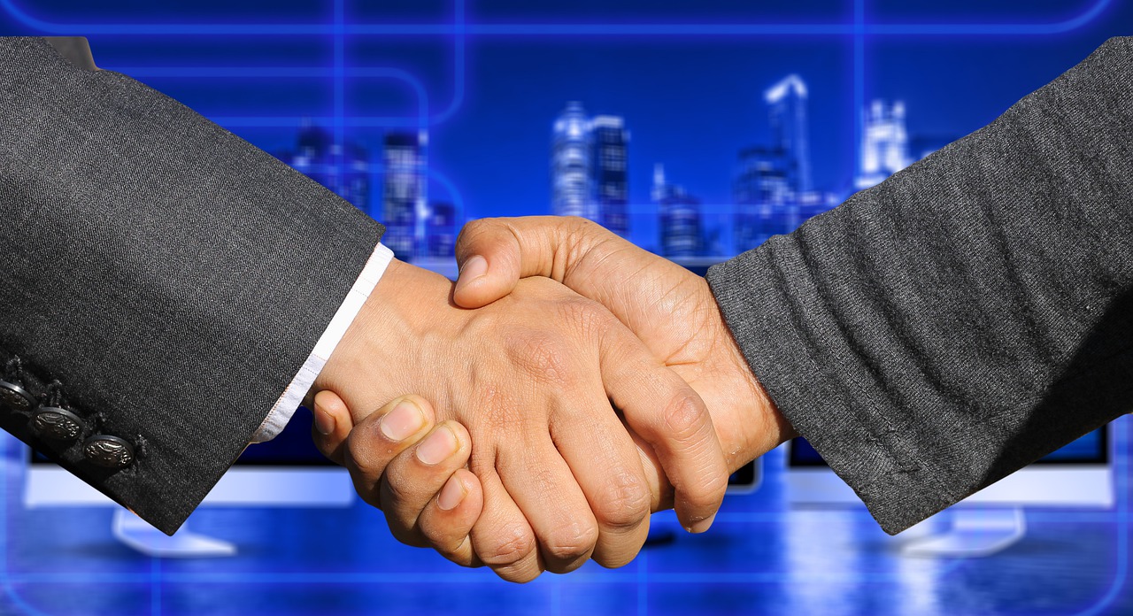 A handshake signifying a merger.