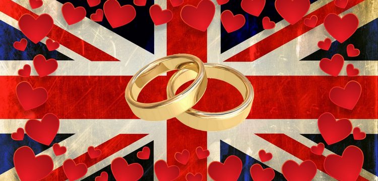 Wedding bands surrounded by hearts on a flag of Great Britain.