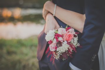Bride with arms around her groom.