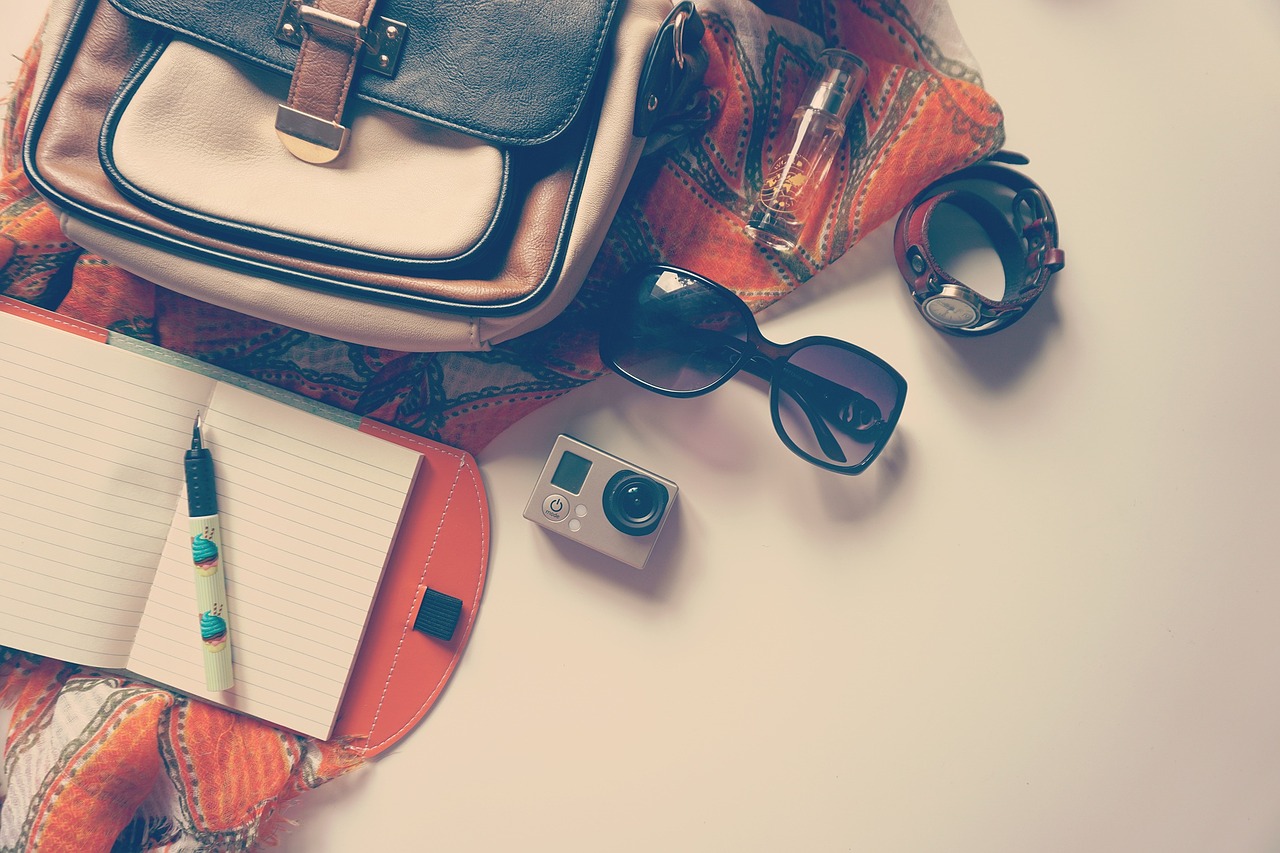 Sunglasses with a bag and notebook.