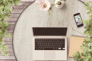 Laptop, cell phone, and flowers.