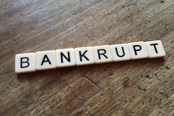 Scrabble letters that spell "bankrupt".
