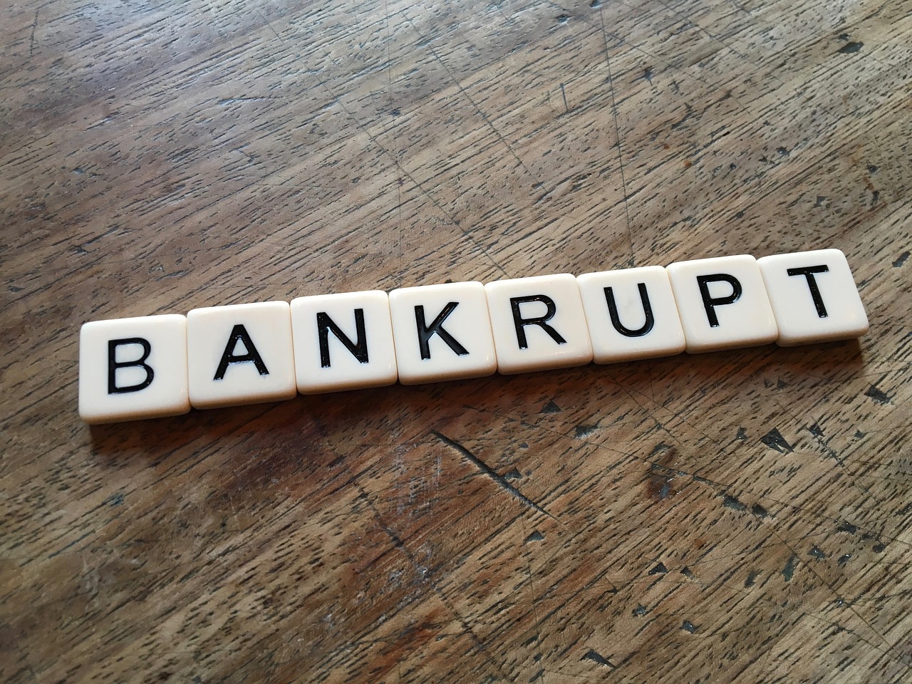 Scrabble letters that spell "bankrupt".