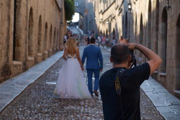 Photographer taking photo of bride and groom.