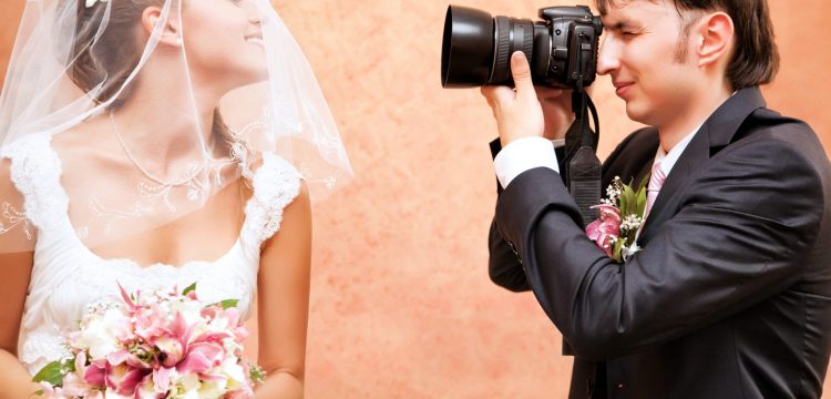Man photographing a bride.