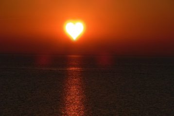 The sun in the shape of a heart.