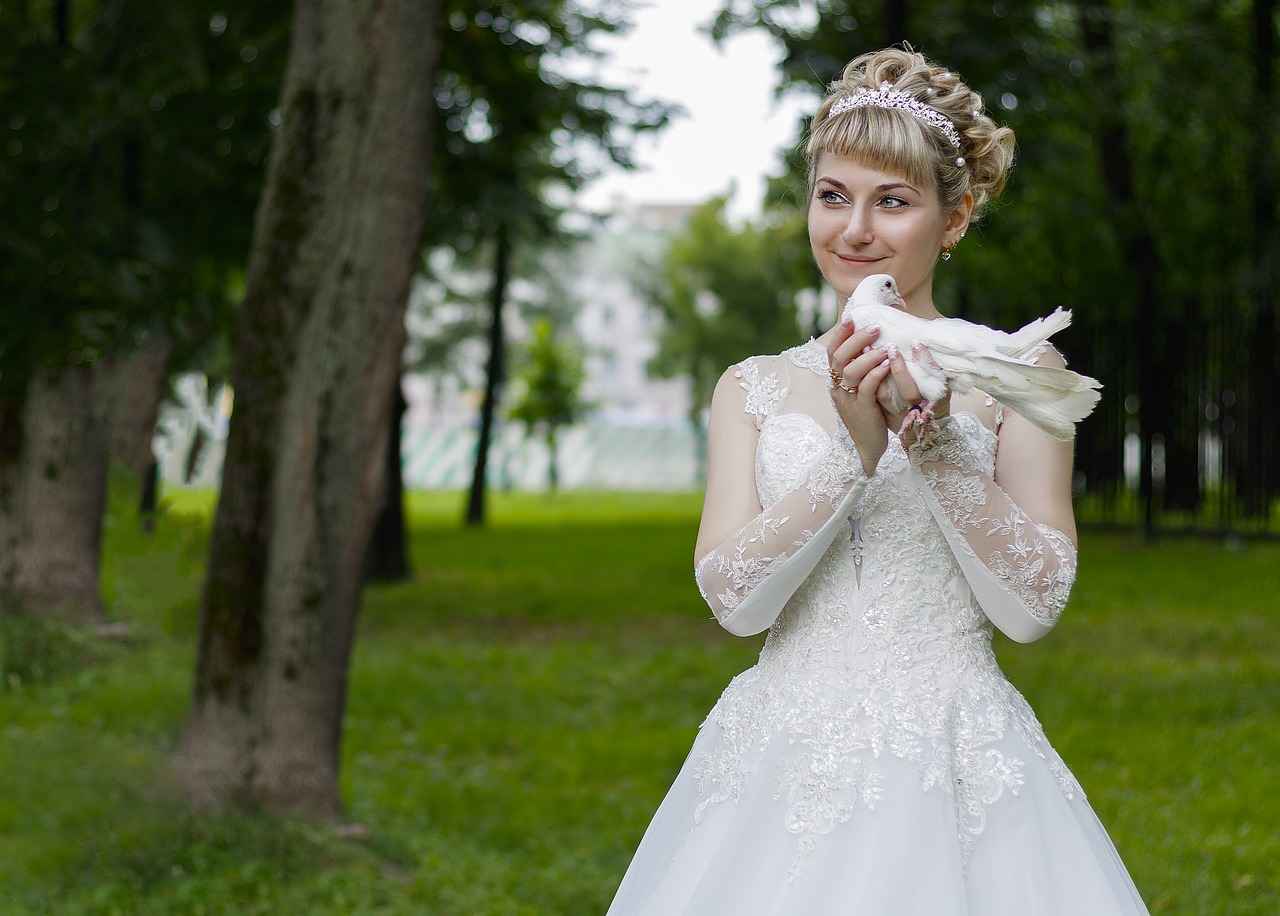 Smiling bride holding a dove.