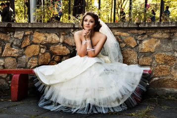 Bride sitting on a bench.