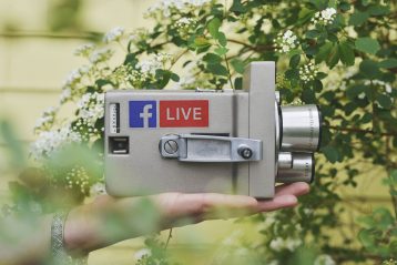 A camcorder with a Facebook Live sticker on it.