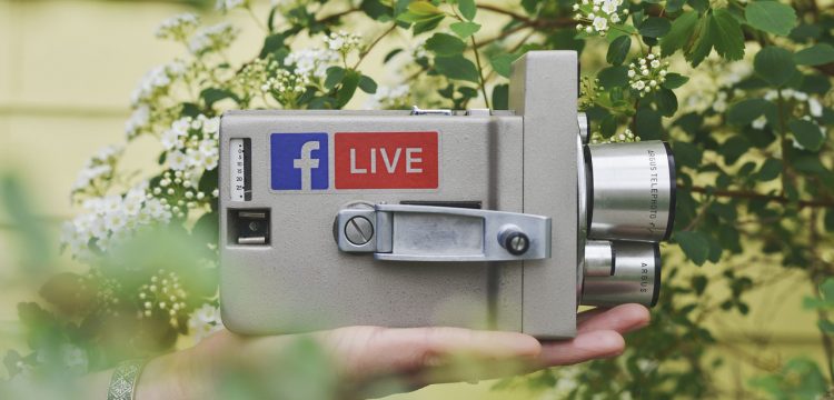 A camcorder with a Facebook Live sticker on it.
