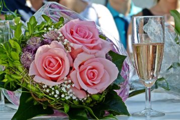 Wedding bouquet and a glass of champagne.