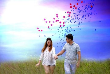 Man and woman walking in field.