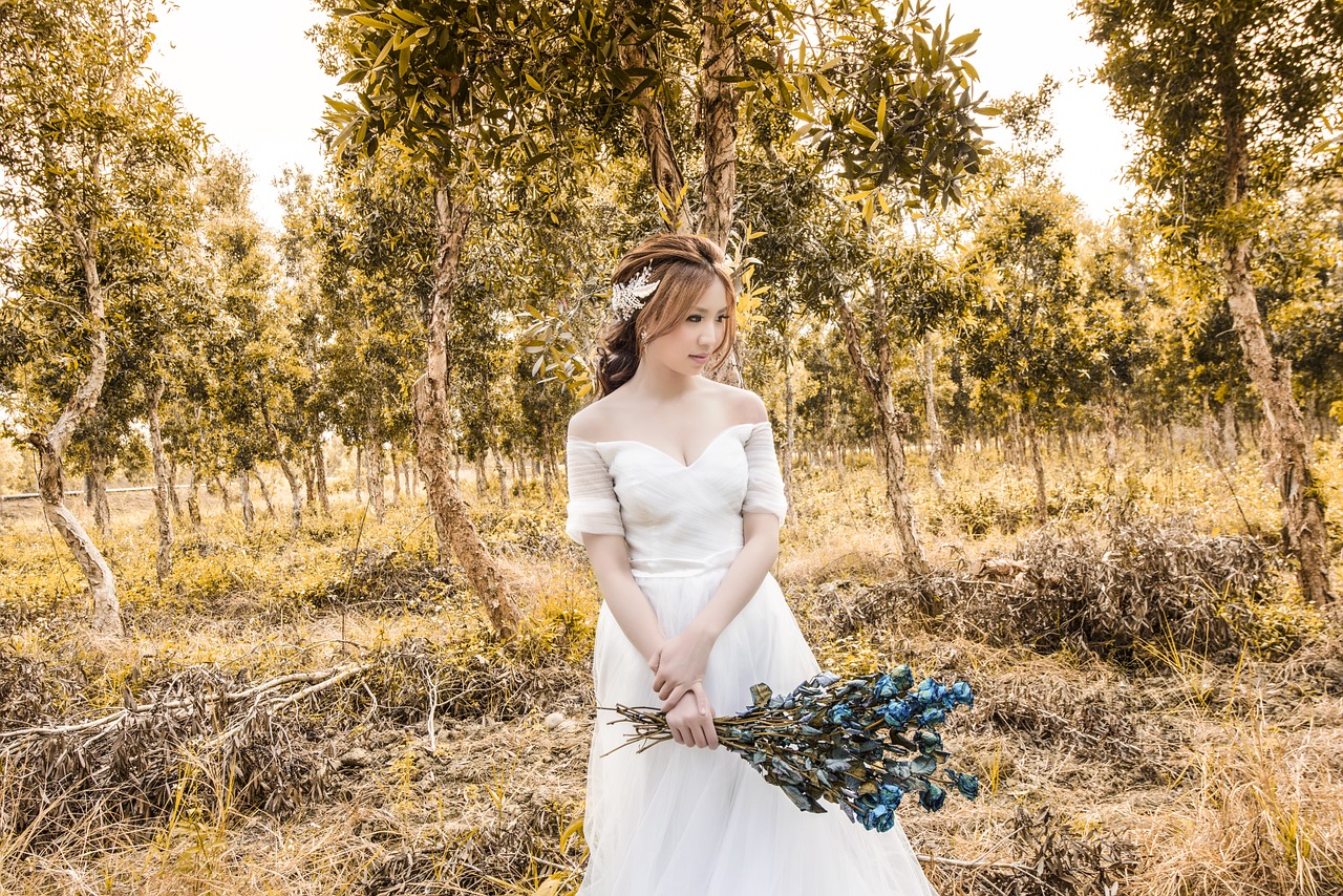 Bride standing in a forest.
