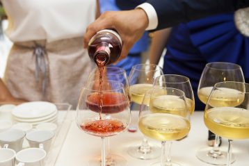 Person pouring alcohol for a toast.