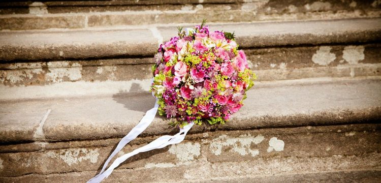 Wedding bouquet on outdoor steps.