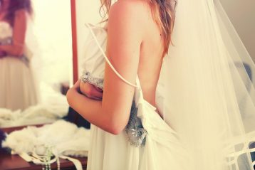 Bride trying on gown.